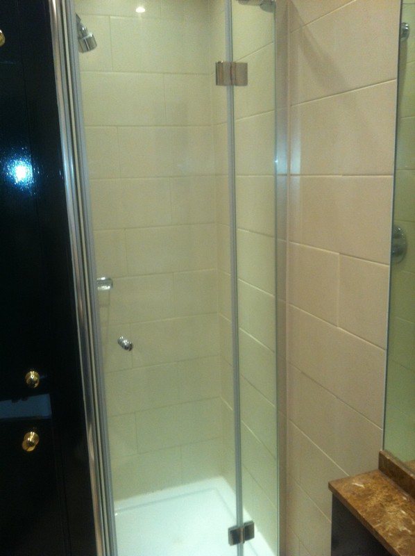 Frameless glass shower enclosure with chrome fittings in New Cross Gate